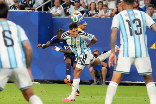 Cape Verde's Sidny Lopes Cabral (13) shoots and scores a goal past Argentina's Nahuel Molina (26) during the World Cup round of 32 soccer match between Argentina and Cape Verde in Miami Gardens, Fla., Friday, July 3, 2026. (AP Photo/Chris Carlson)