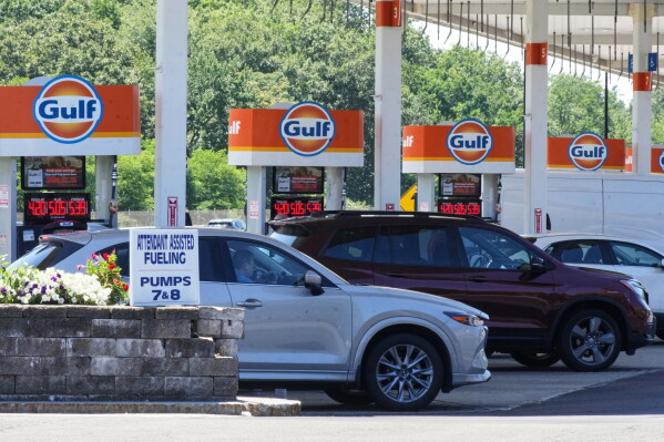 Cars line up at the pumps of a Gulf Oil station on the Massachusetts Turnpike near Boston, Sunday, July 19, 2026. (AP Photo/Gene J. Puskar, File)