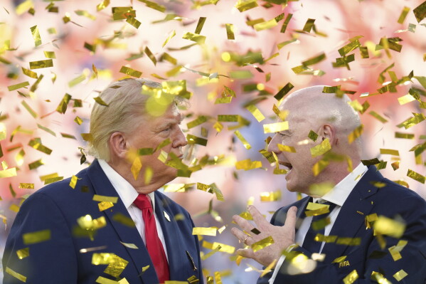 President Donald Trump, left, speaks with FIFA President Gianni Infantino as confetti falls at the conclusion of the World Cup championship final soccer match between Spain and Argentina in East Rutherford, N.J., Sunday, July 19, 2026. (AP Photo/Jacquelyn Martin)