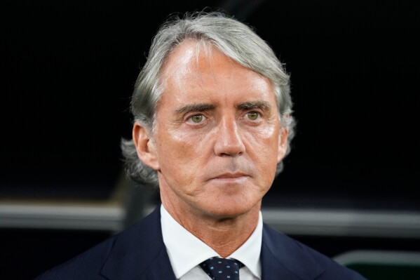 Saudi Arabia's head coach Roberto Mancini stands for the national anthems ahead of the Asian Cup Group F soccer match between Saudi Arabia and Thailand at Education City Stadium, in Al Rayyan, Qatar, Thursday, Jan. 25, 2024. (AP Photo/Aijaz Rahi, file)