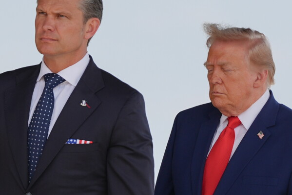 Defense Secretary Pete Hegseth and President Donald Trump attend the dignified transfer of four U.S. service members recently killed in the Middle East, Wednesday, July 22, 2026, at Dover Air Force Base, Del. (AP Photo/Julia Demaree Nikhinson)
