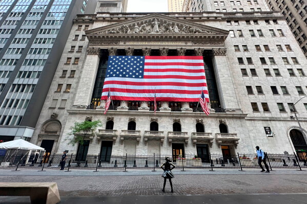 People pass the New York Stock Exchange on May 28, 2024, in New York. (AP Photo/Peter Morgan, File)