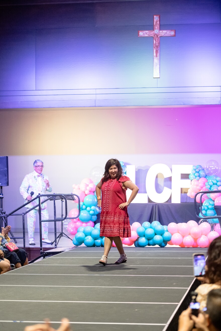 Eva's Hero, Marlene Montes goes down the runway in her flowing red dress.