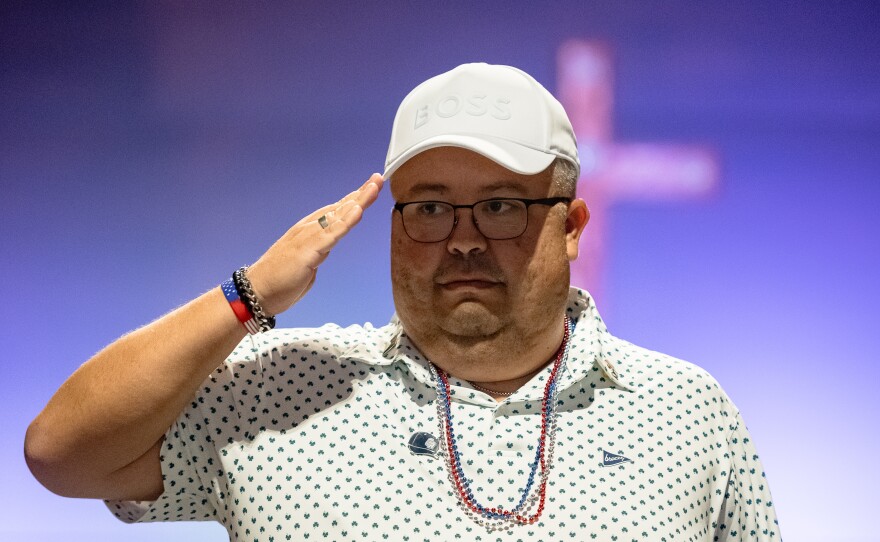 Eva's Hero Juan "Charlie" Villareal salutes down the runway displaying his patriotic pride.