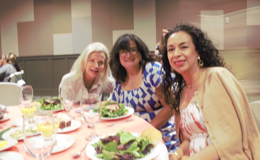 Attendees Mary Moore, Aimee Wauters, and Geneva Lares were excited to see Eva's Heroes strut the runway.