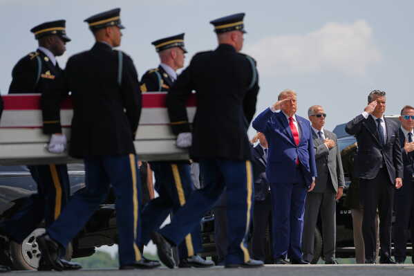President Donald Trump and Secretary of Defense Pete Hegseth, salute as a U.S. Army carry team moves a transfer case containing the remains of Pvt. Isabella Gonzales of Carrollton, Texas, Wednesday, July 22, 2026, at Dover Air Force Base, Del. (AP Photo/Matt Rourke)
