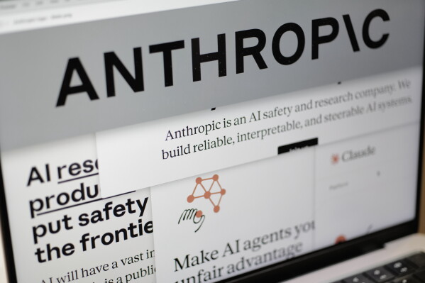 Pages from the Anthropic website and the company's logo are displayed on a computer screen in New York, Feb. 26, 2026. (AP Photo/Patrick Sison, File)