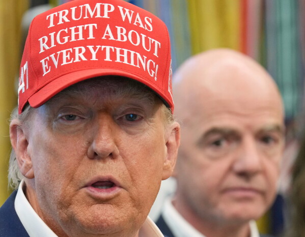 President Donald Trump speaks as FIFA President Gianni Infantino listens in the Oval Office of the White House, Friday, Aug. 22, 2025, in Washington. (AP Photo/Jacquelyn Martin, File)