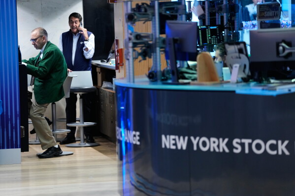 Traders work on the floor at the New York Stock Exchange in New York, Monday, July 6, 2026. (AP Photo/Seth Wenig)