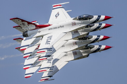 military and civilian aircraft fly at airshow