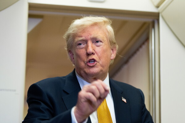 President Donald Trump speaks with reporters in flight on Air Force One after landing at U.S. Air Force Base at RAF Mildenhall, in Suffolk, Eastern England, Wednesday, July 8, 2026. (AP Photo/Alex Brandon)