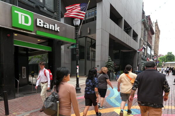 Pedestrians pass a TD Bank location, June 24, 2026, in Boston. (AP Photo/Charles Krupa, File)