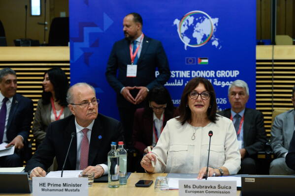 European Commissioner for the Mediterranean Dubravka Suica, right, and Palestinian Prime Minister Mohammad Mustafa participate in a round table meeting of the Palestinian Donor Group at EU headquarters in Brussels, Monday, July 13, 2026. (John Thys, Pool Photo via AP)
