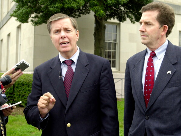 Sen. Lindsey Graham, R-S.C., speaks to the press about the appointment of federal judges during a news conference with Senate candidate Rep. Jim DeMint, right, at the Federal courthouse in Greenville, S.C., Oct. 21, 2004. (AP Photo/Mary Ann Chastain, File)
