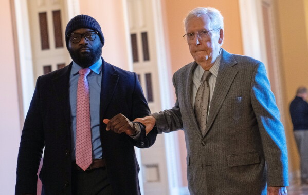 Sen. Mitch McConnell, R-Ky., right, walks through the Capitol, Jan. 15, 2026, in Washington. (AP Photo/Allison Robbert, File)