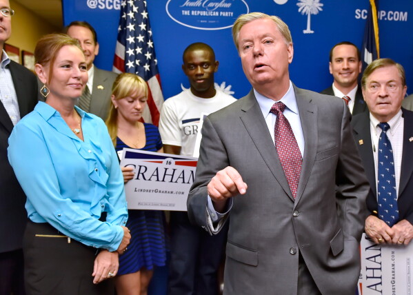 Republican presidential candidate, Sen. Lindsey Graham, R-S.C., accompanied by his sister Darline, left, speaks at the GOP headquarters in Columbia, S.C., Sept. 1, 2015, where he filed for the South Carolina Presidential Primary. (AP Photo/Richard Shiro, File)