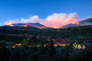 Firefighters drive along Highway 550 as they try to access the Gold Mountain Fire on the town line of Ouray and Ridgeway, Colo., on Sunday, June 28, 2026. (Michael Seamans/The Gazette via AP)