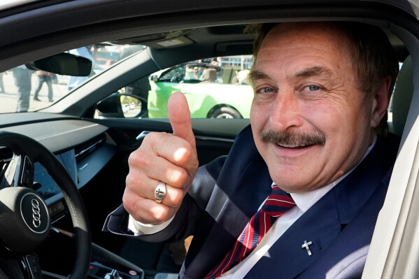 Mike Lindell gives a thumbs up as he passes by a rally for supporters of former President Donald Trump, April 4, 2023, in West Palm Beach, Fla. (AP Photo/Wilfredo Lee, File)