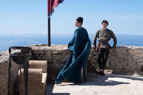 This image released by Universal Pictures shows, from left, Anne Hathaway as Penelope, and Tom Holland as Telemachus, in a scene from "The Odyssey." (Melinda Sue Gordon/Universal Pictures via AP)