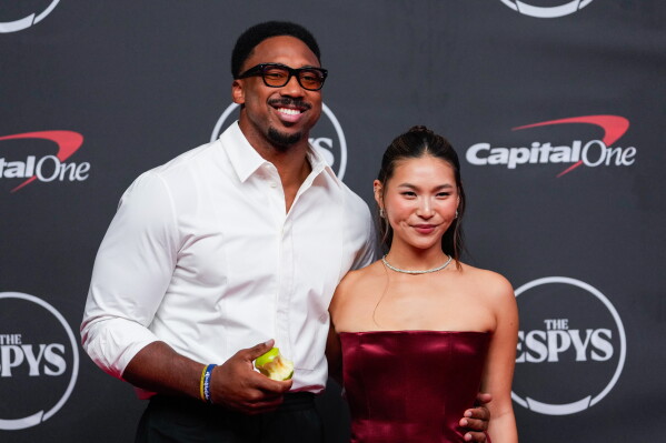 Myles Garrett, left, and Chloe Kim arrive at the ESPY Awards at Lincoln Center on Wednesday, July 15, 2026, in New York. (AP Photo/Yuki Iwamura)