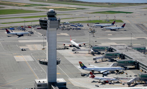 The air traffic control tower rises above terminals at John F. Kennedy International Airport in New York, April 20, 2010. (AP Photo/Mark Lennihan, File)