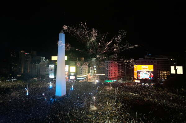 Fans celebrate Argentina's victory over England in a World Cup semifinal soccer match around the Obelisk in downtown Buenos Aires, Argentina, Wednesday, July 15, 2026. (AP Photo/Natacha Pisarenko)