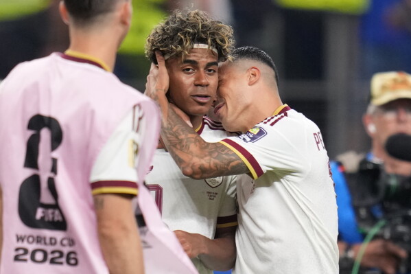 Spain's Pedro Porro, right, and Spain's Lamine Yamal celebrate after the World Cup semifinal soccer match between France and Spain in Arlington, Texas, near Dallas, Tuesday, July 14, 2026. (AP Photo/Abbie Parr)