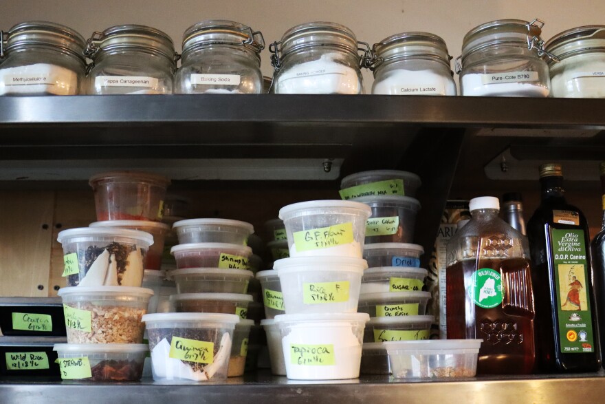 Stacked plastic restaurant containers sit on the shelf of the kitchen of Stages at One Washington in Dover