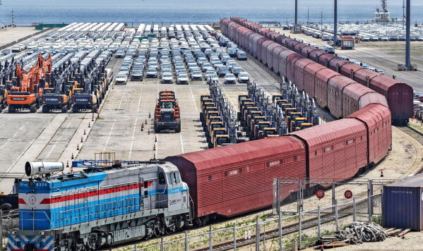 Heavy equipment and cars are prepared for shipment by rail in Yantai, eastern China's Shandong province, on June 20, 2026. (Chinatopix via AP) CHINA OUT