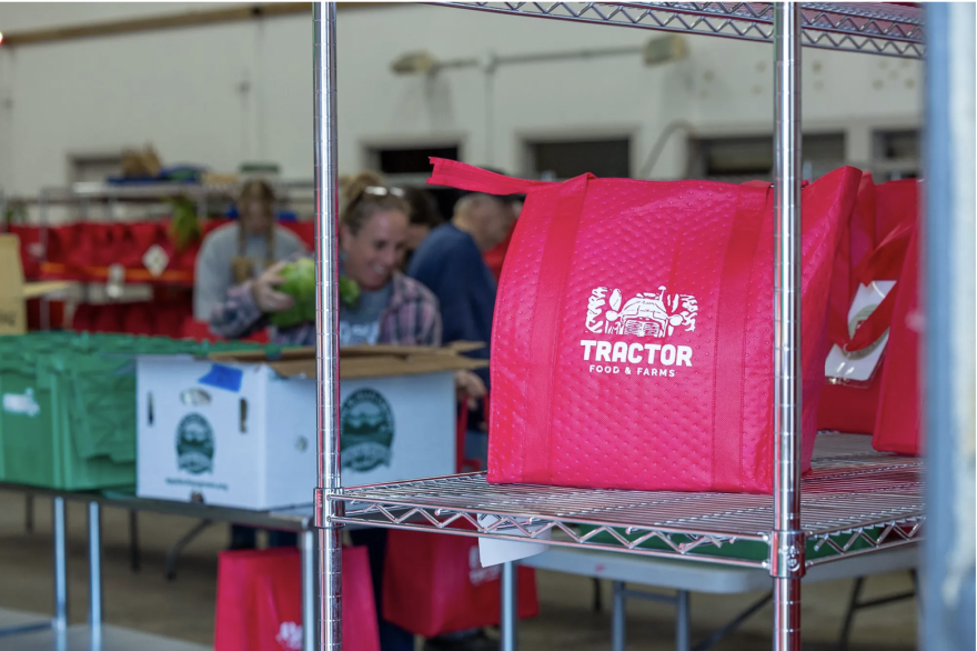 Volunteers and staff members at TRACTOR Food & Farms in Spruce Pine pack fresh produce in their warehouse.