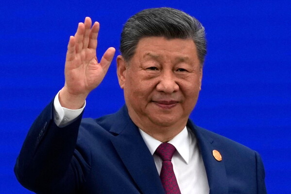 Chinese President Xi Jinping waves as he arrives at the opening ceremony for the World AI Conference in Shanghai, Friday, July 17, 2026. (AP Photo/Ng Han Guan, Pool)