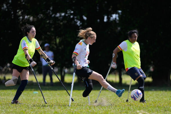 Players vie for the ball during a women's amputee soccer clinic in Santa Cruz, Bolivia, Friday, July 17, 2026. (AP Photo/Juan Karita)