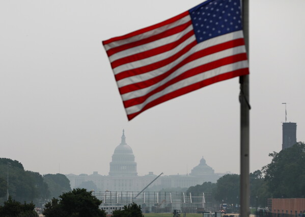 The U.S. Capitol is seen, as smoke from wildfires blankets the sky, Friday, July 17, 2026, in Washington. (AP Photo/Rahmat Gul)
