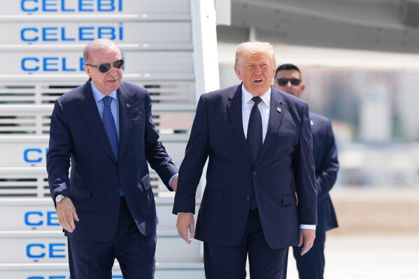 President Donald Trump walks with Turkish President Recep Tayyip Erdogan, left, upon arriving for the NATO summit in Ankara, Turkey, Tuesday, July 7, 2026. (AP Photo/Alex Brandon)