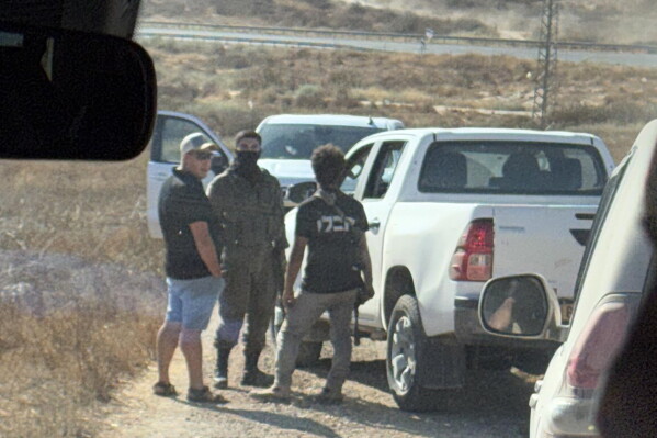 In this photo provided by Cameron Kasky, armed men block the road, stopping vehicles containing U.S. Rep. Ro Khanna, D-Calif., and his delegation near the West Bank village of Khirbet Zanuta, Wednesday, July 8, 2026. (Cameron Kasky via AP)