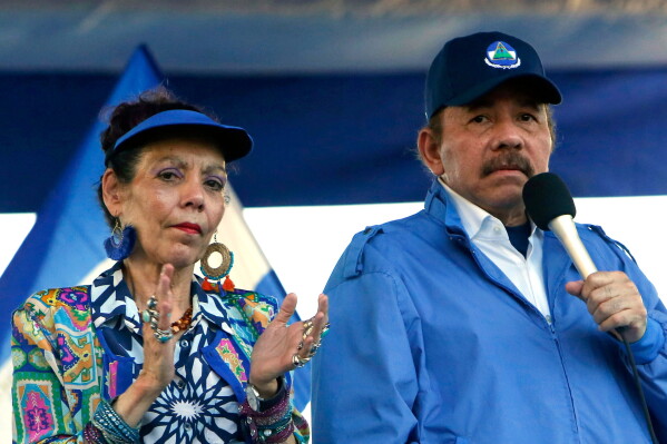 President Daniel Ortega and his wife, Vice President Rosario Murillo, lead a rally in Managua, Nicaragua, Sept. 5, 2018. (AP Photo/Alfredo Zuniga, File)