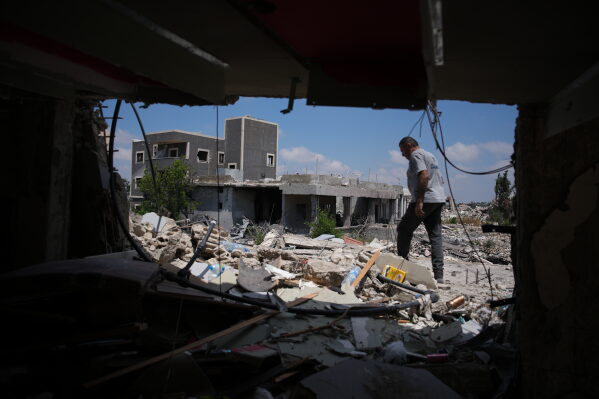 A resident inspects the damage to his home, destroyed in an Israeli airstrike during the Israel-Hezbollah war in Ghandouriyeh village, southern Lebanon, Tuesday, July 21, 2026. (AP Photo/Hassan Ammar)