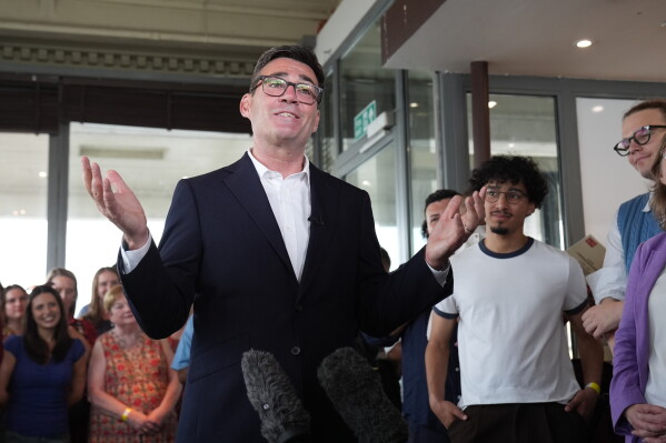 Newly confirmed Labour Party leader Andy Burnham speaks with local stakeholders and party supporters during a visit to Gravesend Town Pier, Gravesend , England, Friday July 17, 2026. (Gareth Fuller/PA via AP)