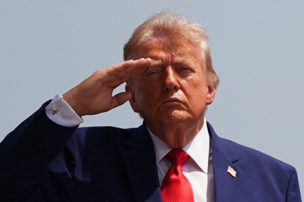 President Donald Trump salutes as a U.S. Army carry team moves a transfer case containing the remains of Pvt. Isabella Gonzales of Carrollton, Texas, Wednesday, July 22, 2026, at Dover Air Force Base, Del. (AP Photo/Julia Demaree Nikhinson)