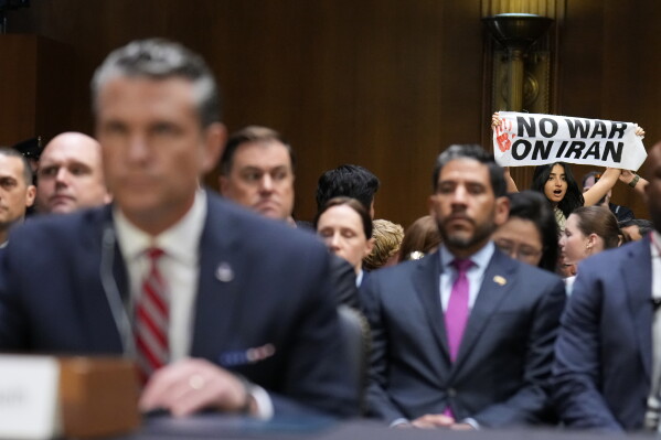 A protester interrupts Defense Secretary Pete Hegseth as he testifies at a hearing of the Senate Appropriations Committee, Tuesday, July 21, 2026, on Capitol Hill in Washington. (AP Photo/Jacquelyn Martin)