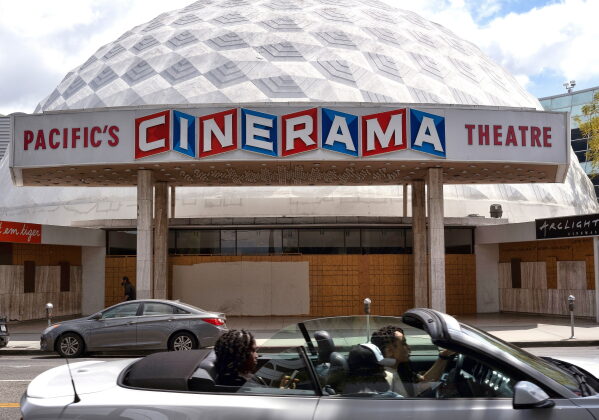 A motorist drives past the Cinerama Dome movie theater in Los Angeles on April 25, 2021. (AP Photo/Richard Vogel, File)