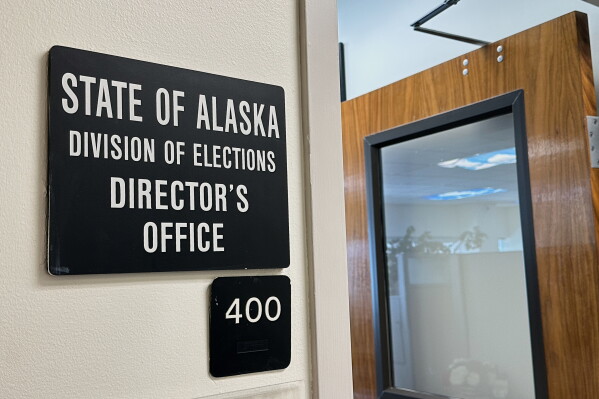 A sign hangs outside the director's office of the Alaska Division of Elections, March 19, 2026, in Juneau, Alaska. (AP Photo/Becky Bohrer, File)