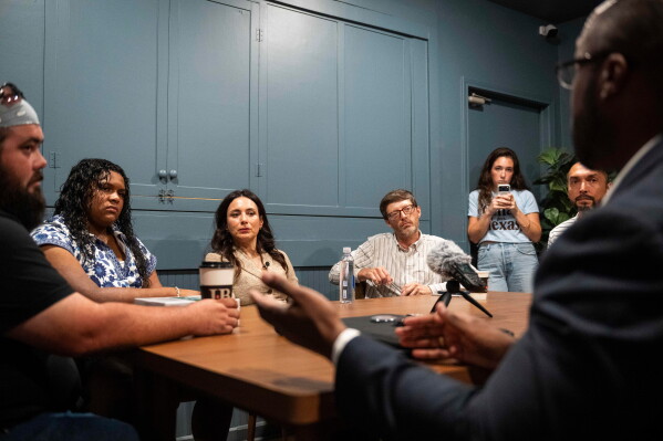 Democratic candidate for Texas governor Gina Hinojosa, third from the left, listens to Stephen Sanders, right, during a roundtable discussion on data centers, Saturday, July 18, 2026, in Lubbock, Texas. (AP Photo/Justin Rex)
