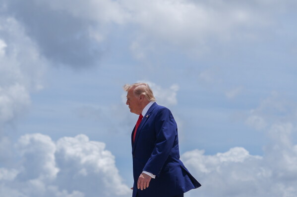 President Donald Trump walks to the presidential limousine, known as The Beast, after arriving on Air Force One at Dobbins Air Reserve Base, Wednesday, July 22, 2026, in Marietta, Ga. (AP Photo/Julia Demaree Nikhinson)