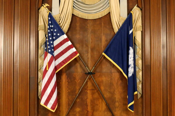 The U.S. and South Carolina flags hang in the South Carolina statehouse, March 16, 2021, in Columbia, S.C . (AP Photo/Jeffrey Collins, File)