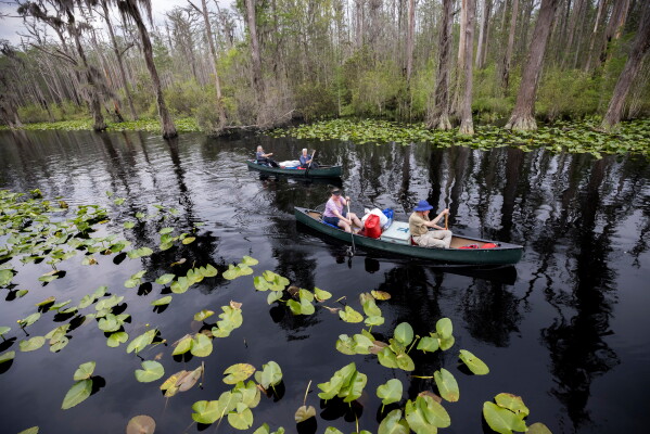 Visitors return to Stephen C. Foster State Park after an overnight camping trip on the Red Trail in the Okefenokee National Wildlife Refuge in Fargo, Ga., April 6, 2022. (AP Photo/Stephen B. Morton, File)