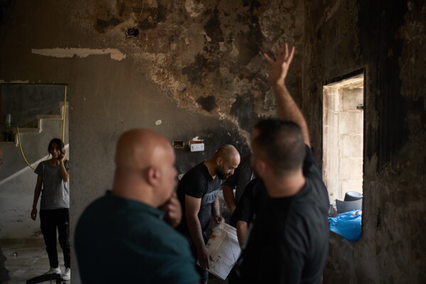 Palestinians gather to repair a damaged house following an attack by Israeli settlers the previous day in the village of Sarra, near the West Bank city of Nablus, Saturday, July 25, 2026. (AP Photo/Leo Correa)