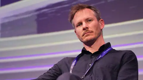 Bloomberg via Getty Images Thomas Wolf, co-founder and chief science officer at Hugging Face, during the Raise summit in Paris in July 2025