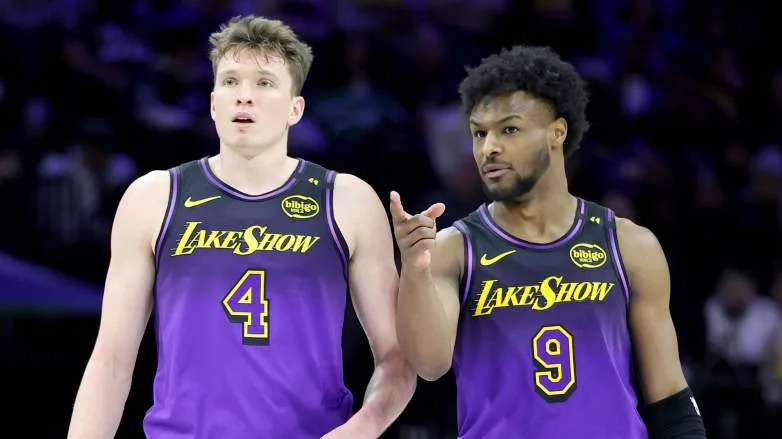 PHILADELPHIA, PENNSYLVANIA - JANUARY 28: Bronny James #9 of the Los Angeles Lakers talks to Dalton Knecht #4 during a game against the Philadelphia 76ers at the Wells Fargo Center on January 28, 2025 in Philadelphia, Pennsylvania. NOTE TO USER: User expressly acknowledges and agrees that, by downloading and or using this photograph, User is consenting to the terms and conditions of the Getty Images License Agreement. (Photo by Emilee Chinn/Getty Images)