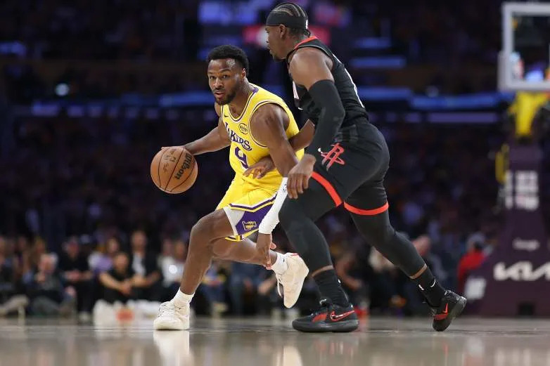 LOS ANGELES, CALIFORNIA - APRIL 18: Bronny James #9 of the Los Angeles Lakers dribbles into the defense of Aaron Holiday #0 of the Houston Rockets during the first half of Game One of the First Round of the NBA Western Conference Playoffs at Crypto.com Arena on April 18, 2026 in Los Angeles, California. (Photo by Sean M. Haffey/Getty Images)